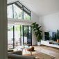 Interior of contemporary cozy living room with modern TV and soft armchairs in daylight