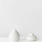 White Ceramic Chicken Figurine on White Surface